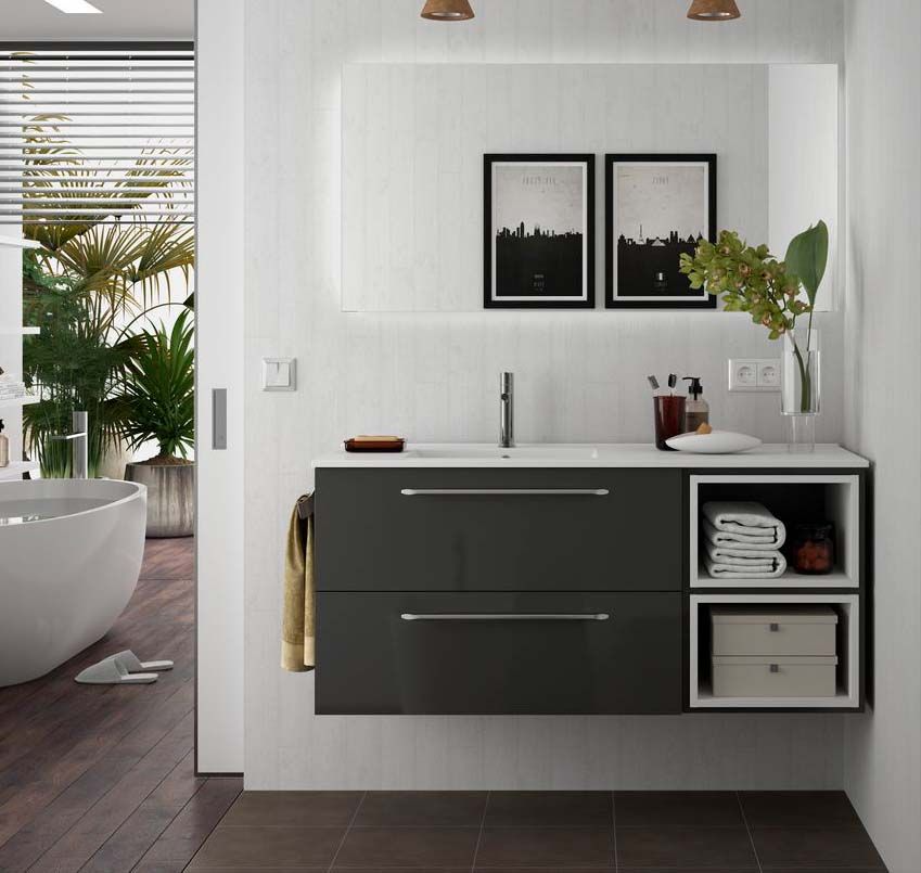 Un baño con un lavabo y dos cuadros en la pared.
