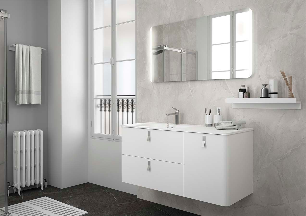 Un baño con lavabo, espejo y radiador.