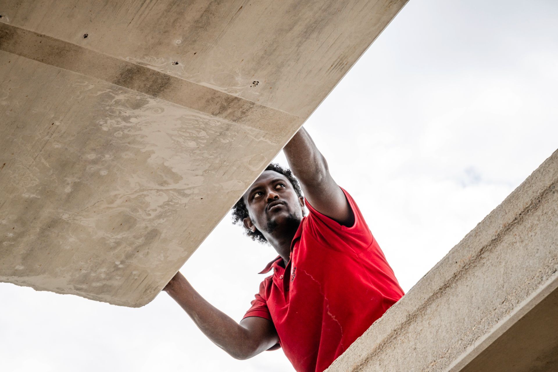 Arbeiter unter Betonplatte bei Montagearbeiten