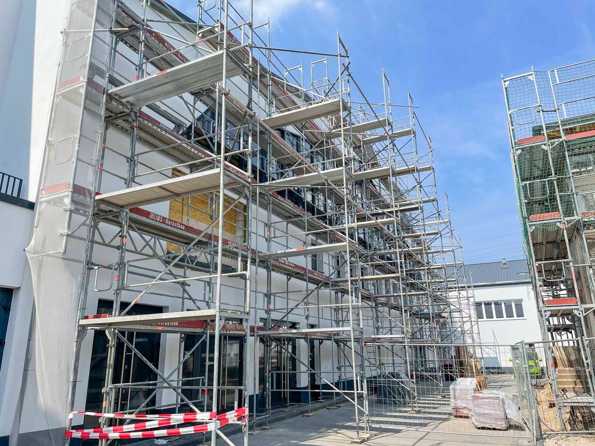 Gebäudefassade wird renoviert und ist eingerüstet; Außenansicht.
