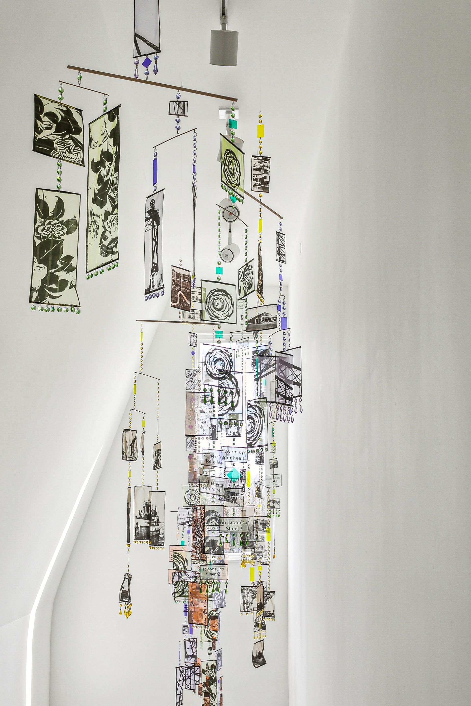 A white wall with a bunch of pictures on it