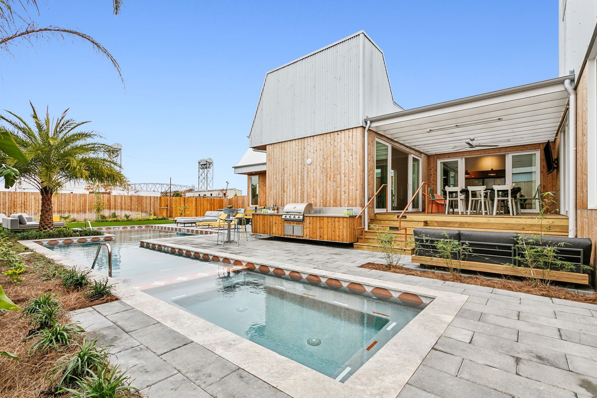 A large house with a swimming pool in front of it.