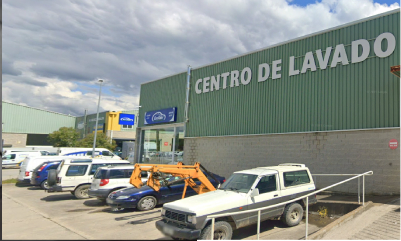 Autos deportivos rojos dentro de una instalación de lavado de automóviles.