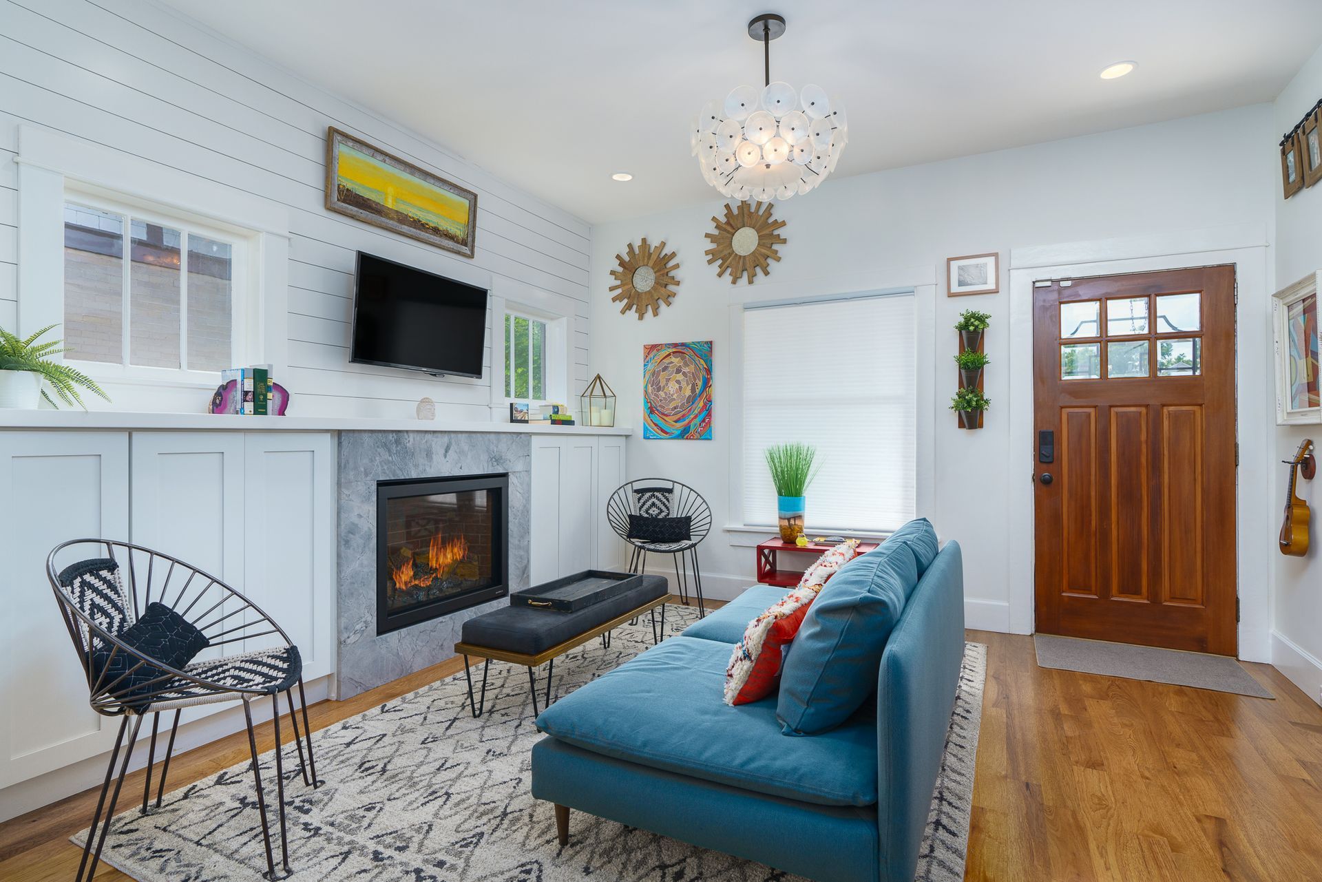 Cozy cabin interior with fireplace, deck views, and wood accents.