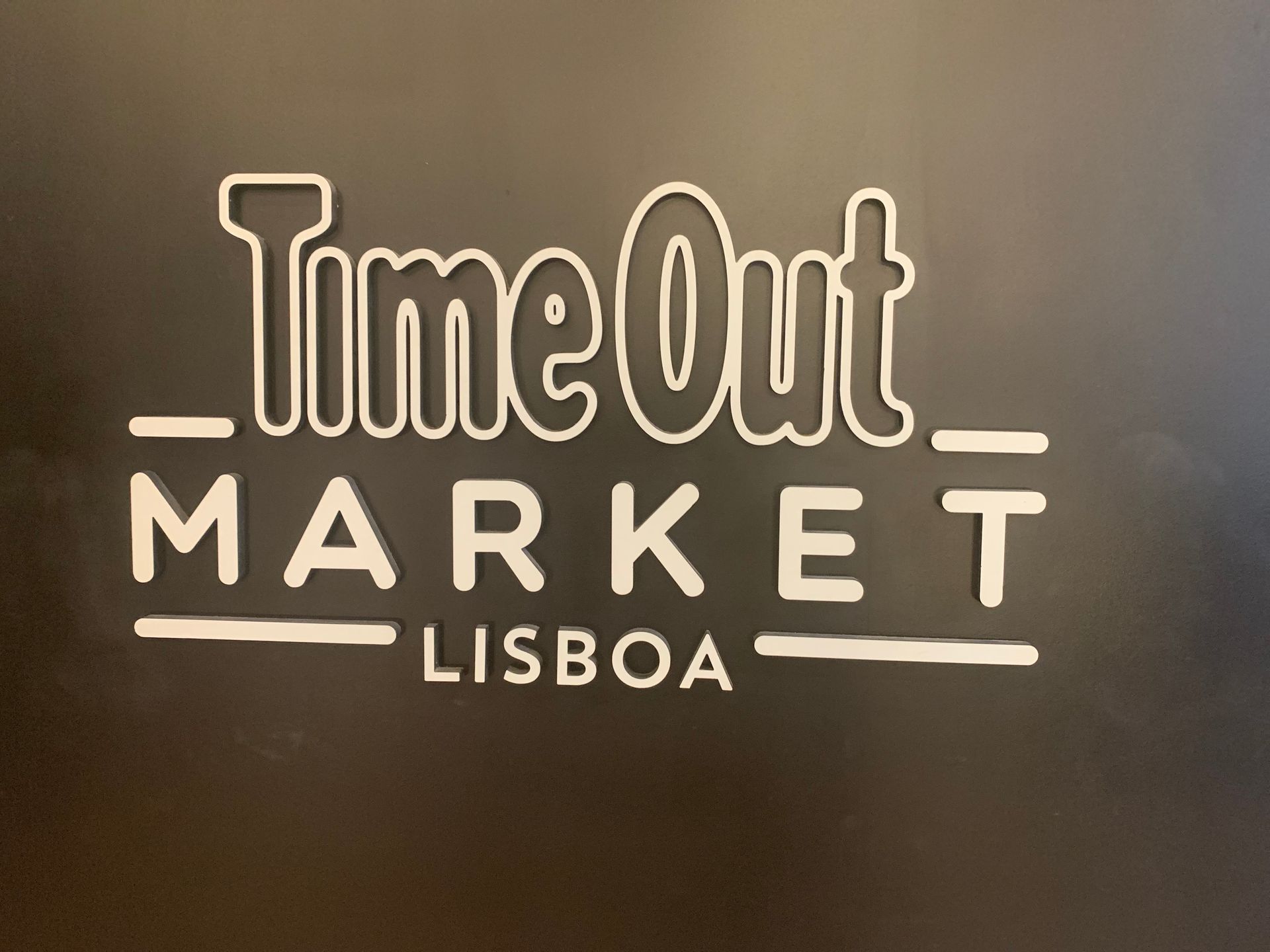 A sign that says time out market lisboa on it