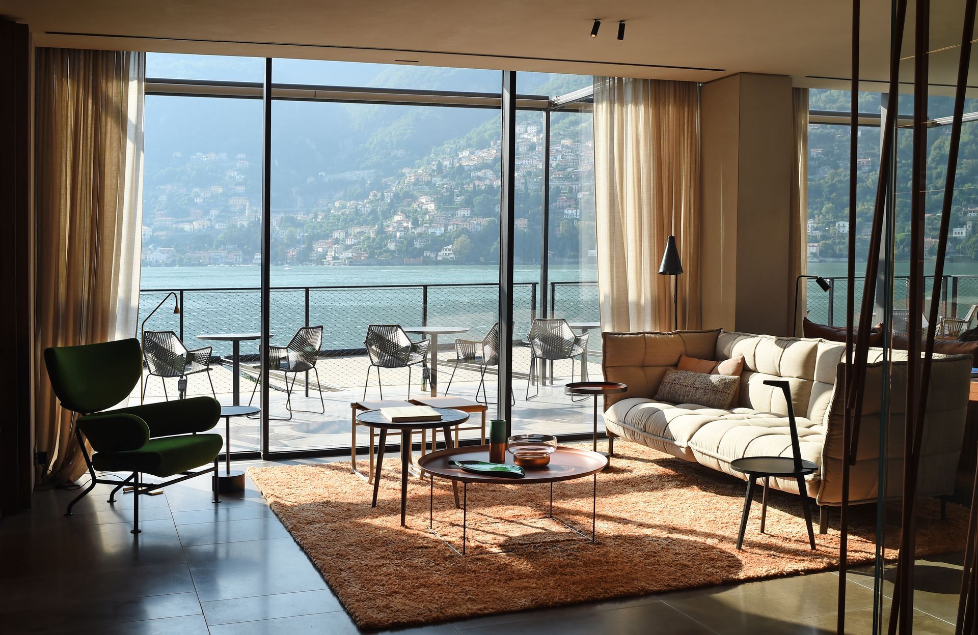 A living room with a view of a lake and mountains