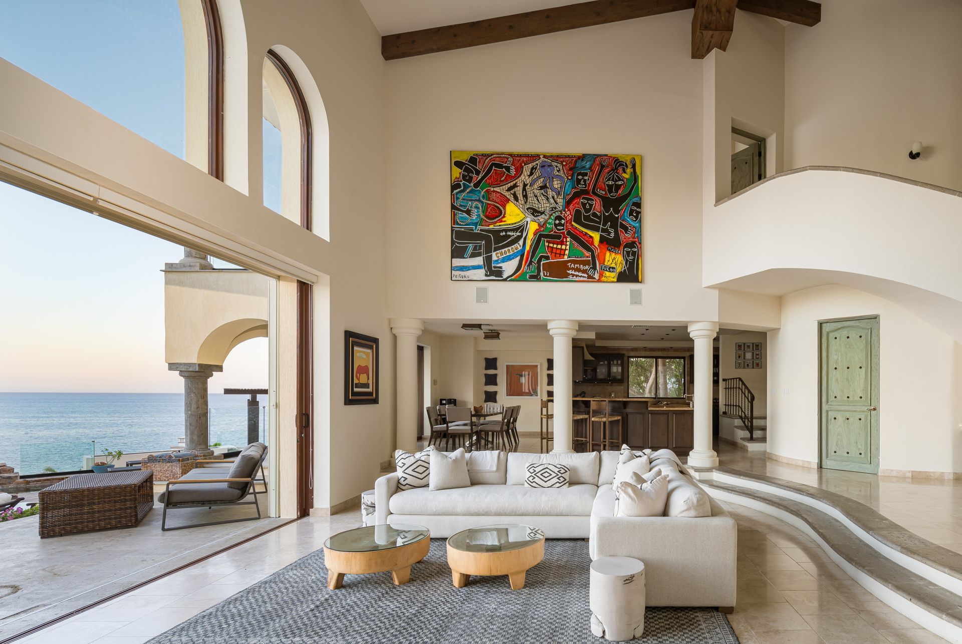 There is a large painting on the wall above the couch in the living room.