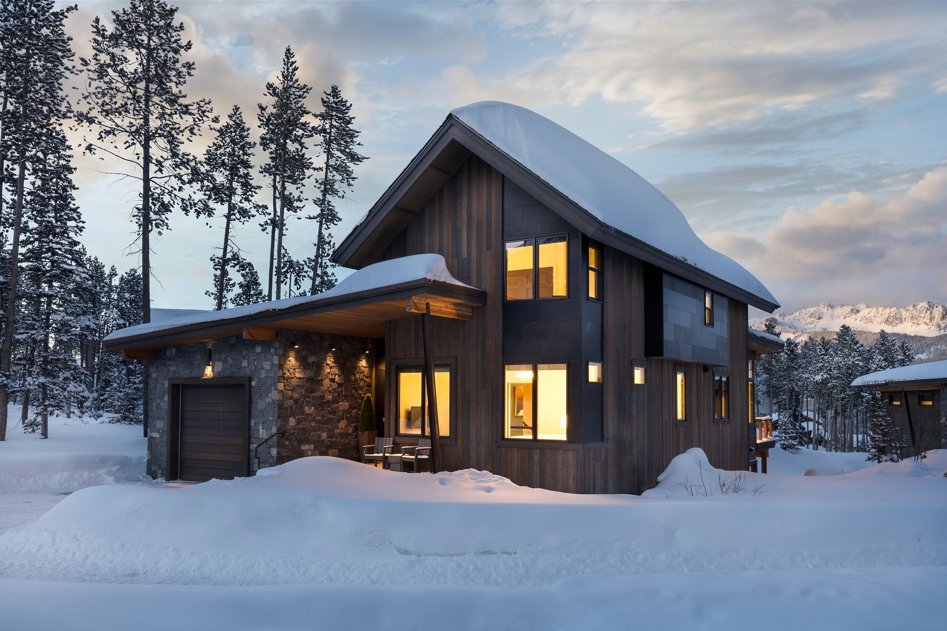 A house in the snow with a mountain in the background