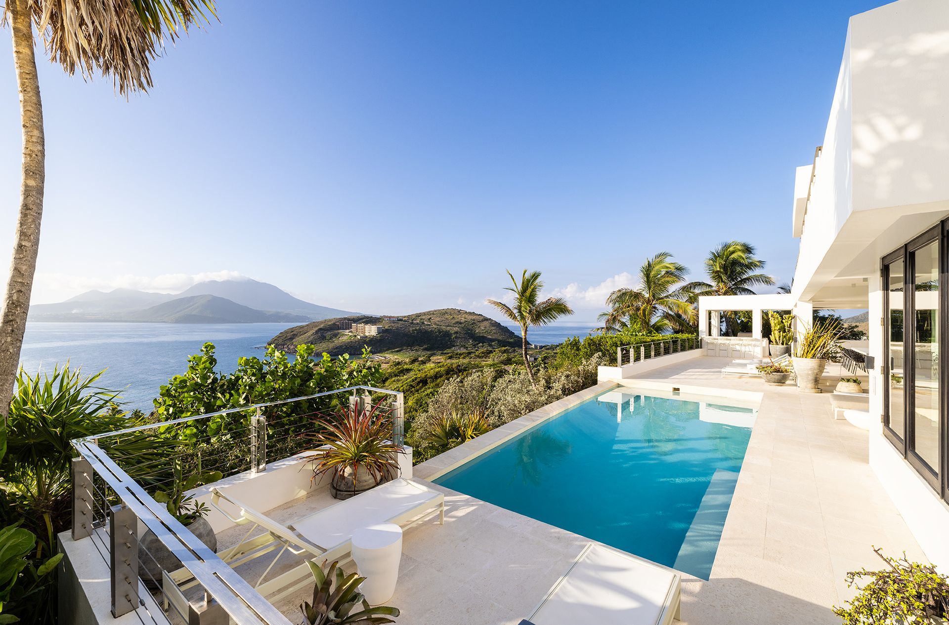 A large swimming pool with a view of the ocean