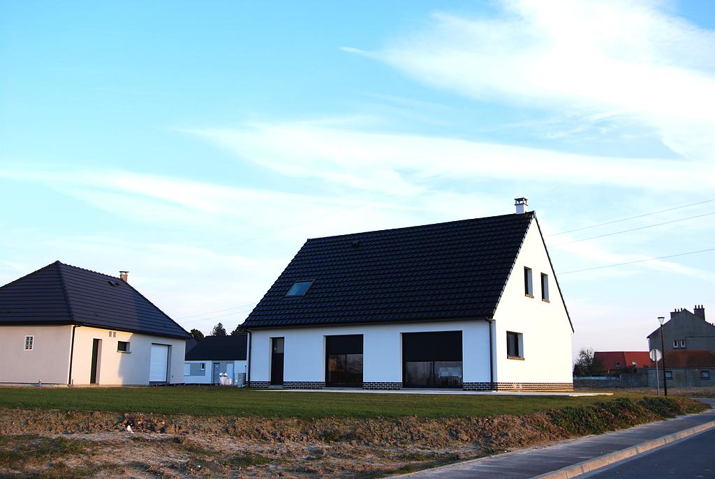 Vue sur l'arrière d'une maison individuelle neuve possédant de nombreuses baies vitrées