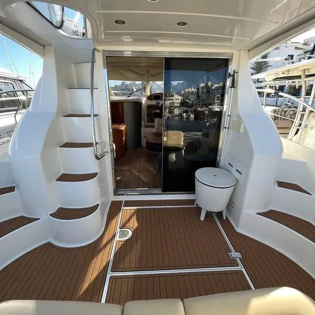 The inside of a boat with stairs and a stool