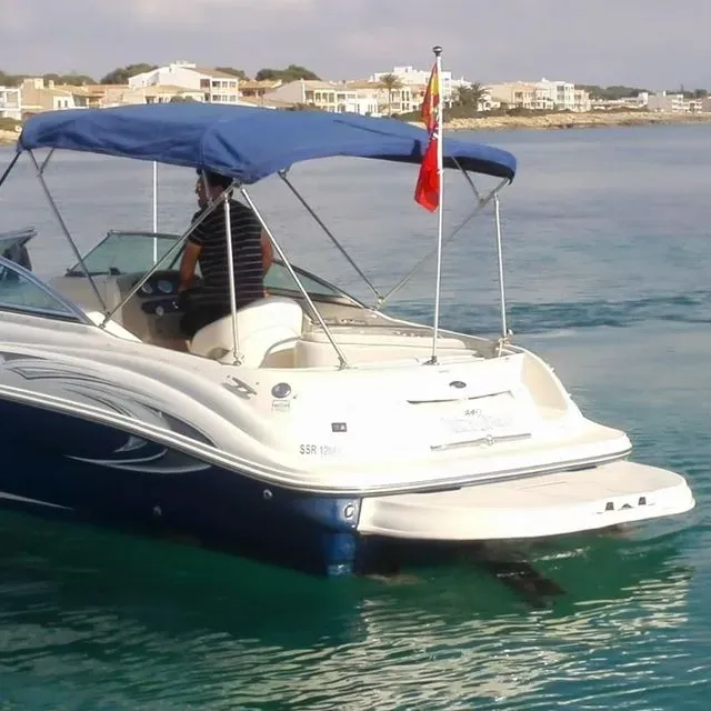 A boat with a blue canopy is in the water