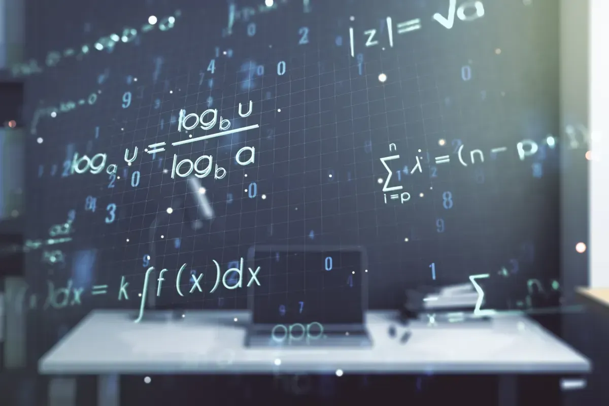 Ordenador portátil sobre un escritorio con ecuaciones matemáticas superpuestas sobre un fondo oscuro.