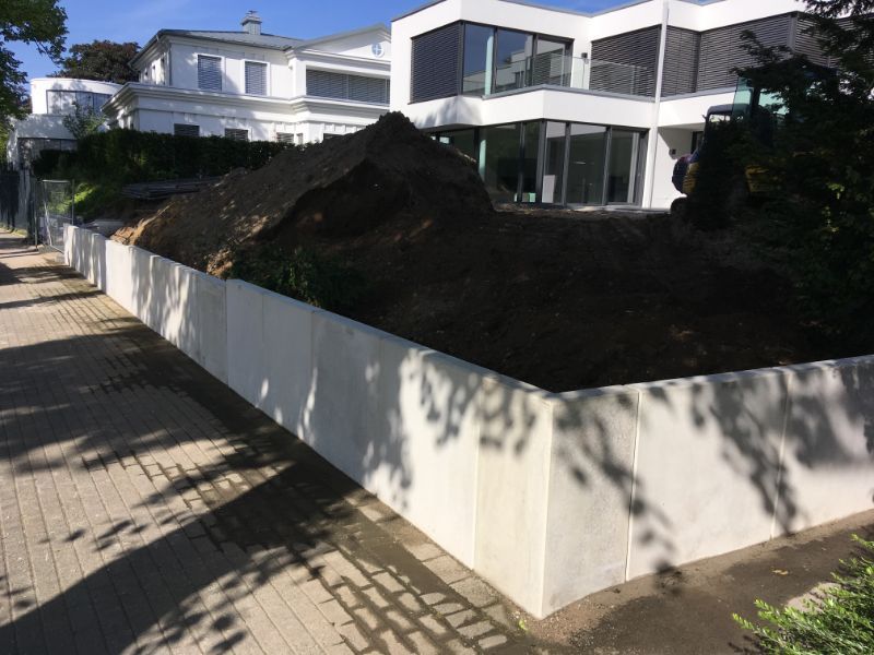 neue weiße Mauer vor einem Haus