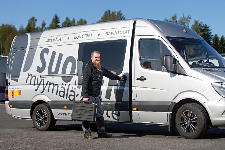 Mies avaa auton sivuovea