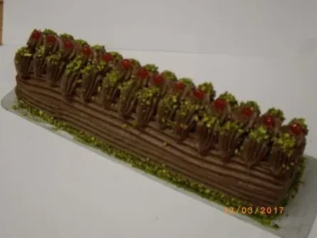 Schokoladen-Weihnachtskuchen mit Erdbeeren und grüner Garnierung auf einem Tablett