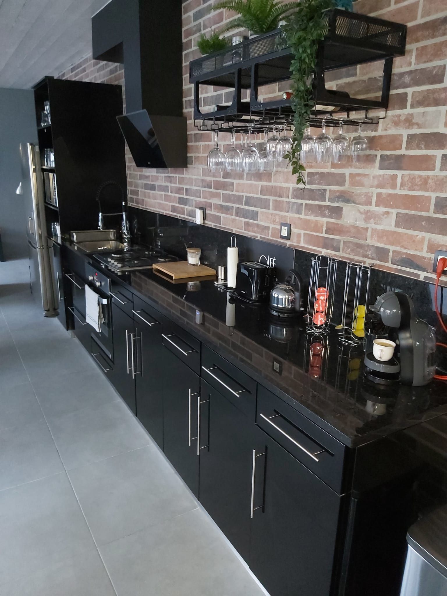 Cuisine avec mur en briques et étagères décoratives