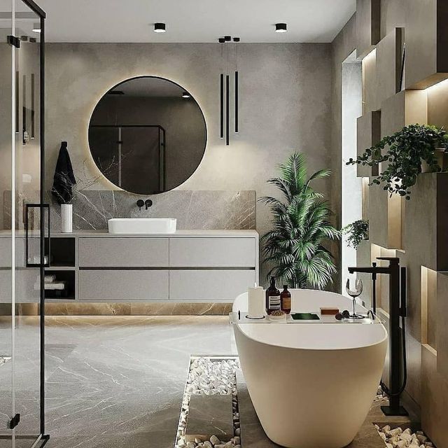 Un baño con bañera, lavabo, espejo y plantas.