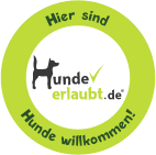 A green circle with a dog in it and the words hier sind hunde erlaubt.de hunde willkommen.
