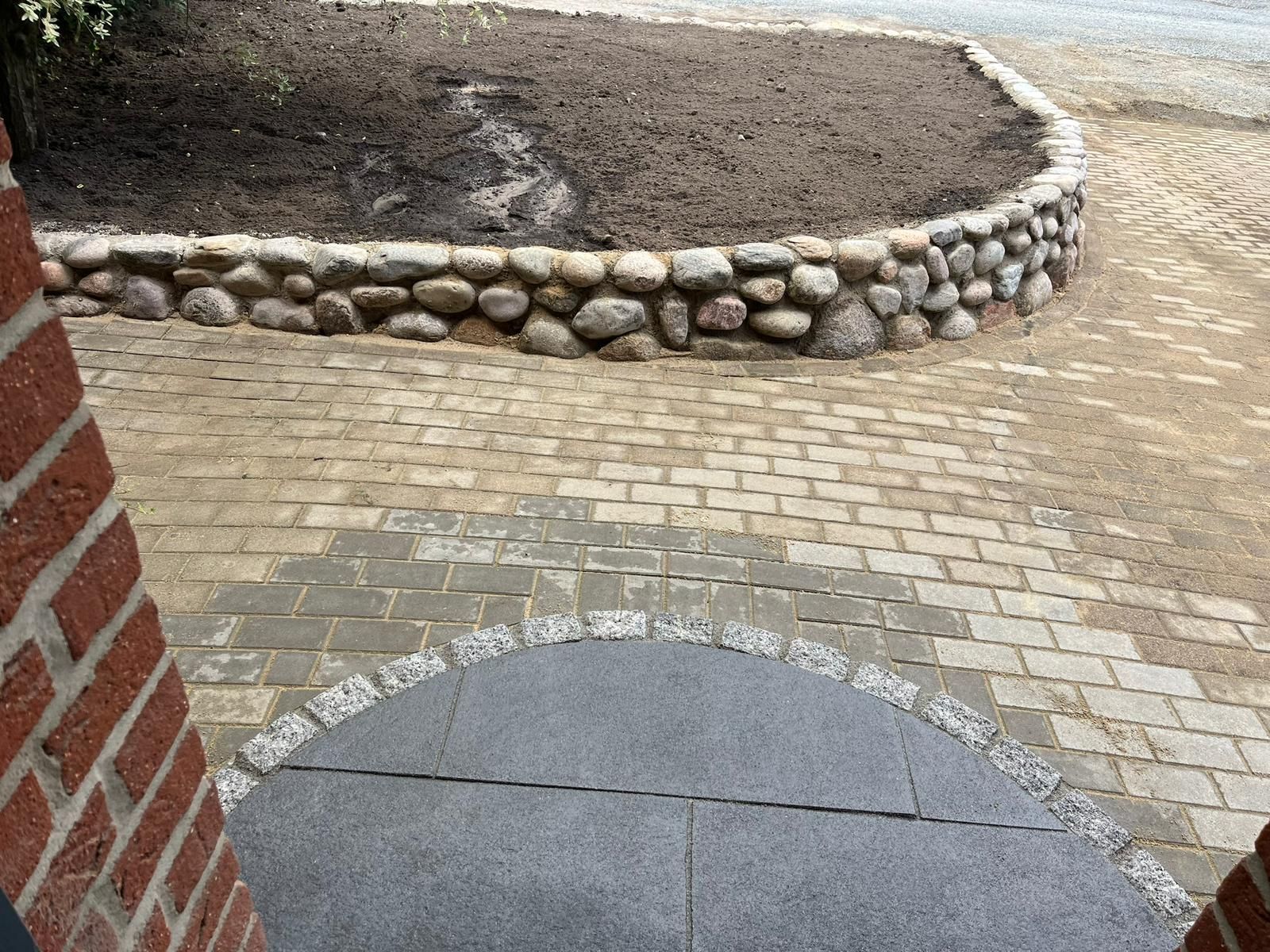 Ein gemauerter Gehweg, umgeben von einer Steinmauer