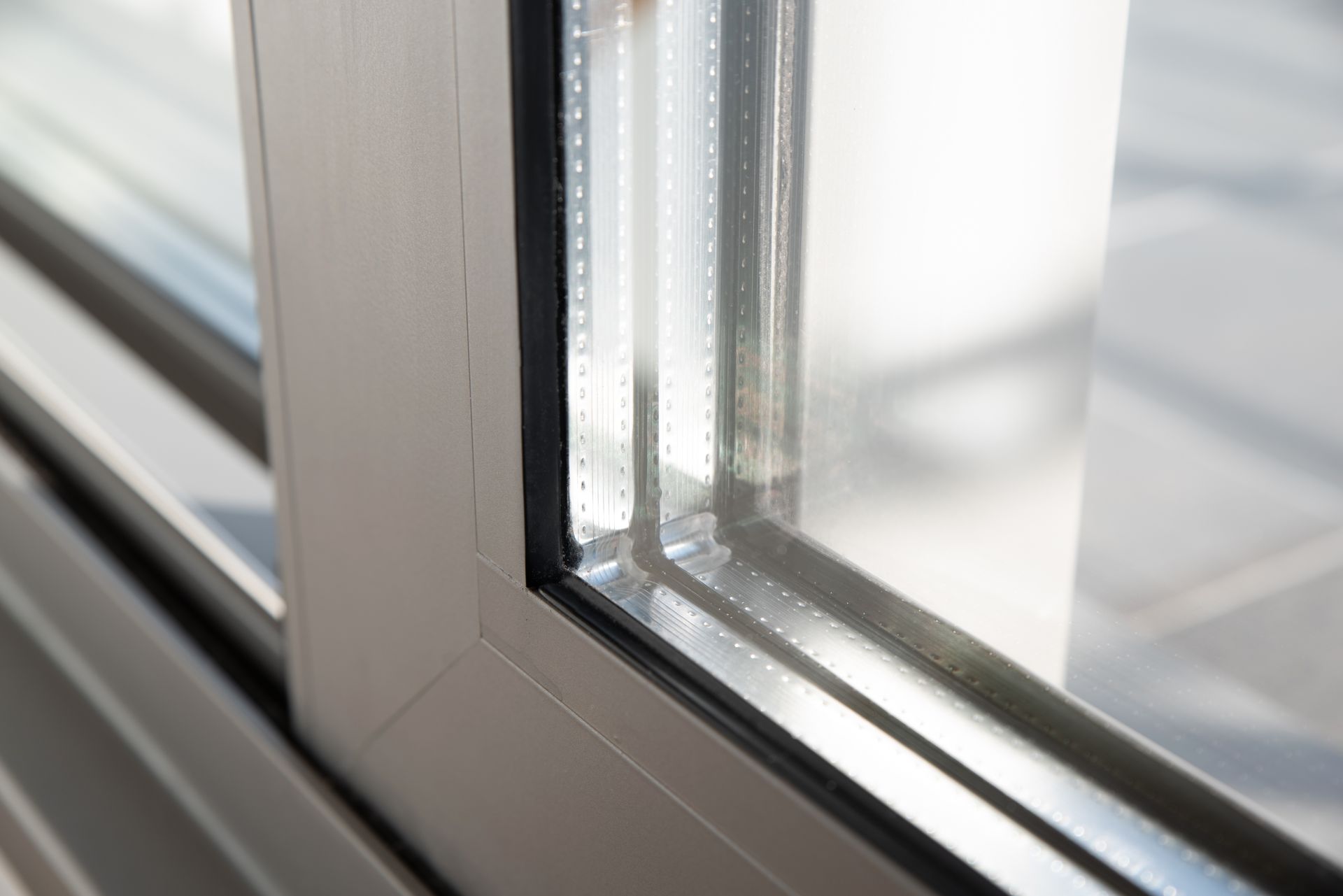 Gros plan sur un cadre de fenêtre moderne avec des vitres et une garniture métallique