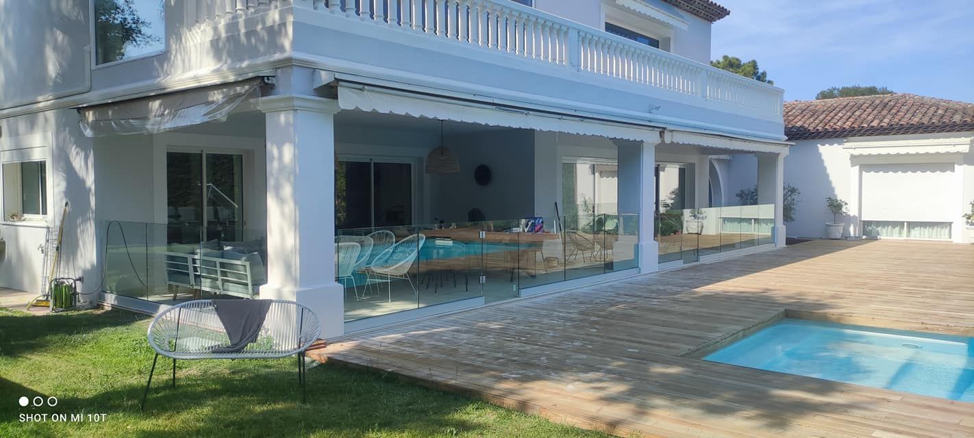 Garde-corps en verre d'une grande maison blanche avec balcon