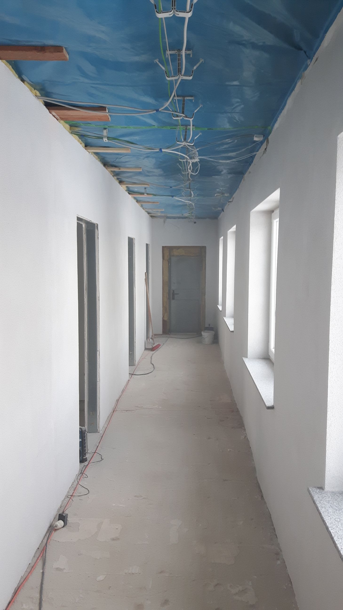Installation von Elektro- und Versorgungsleitungen an der Rohbaudecke.