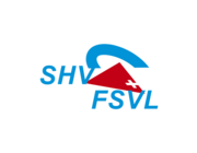 Deux parapentes volent au dessus d'un paysage rocheux.