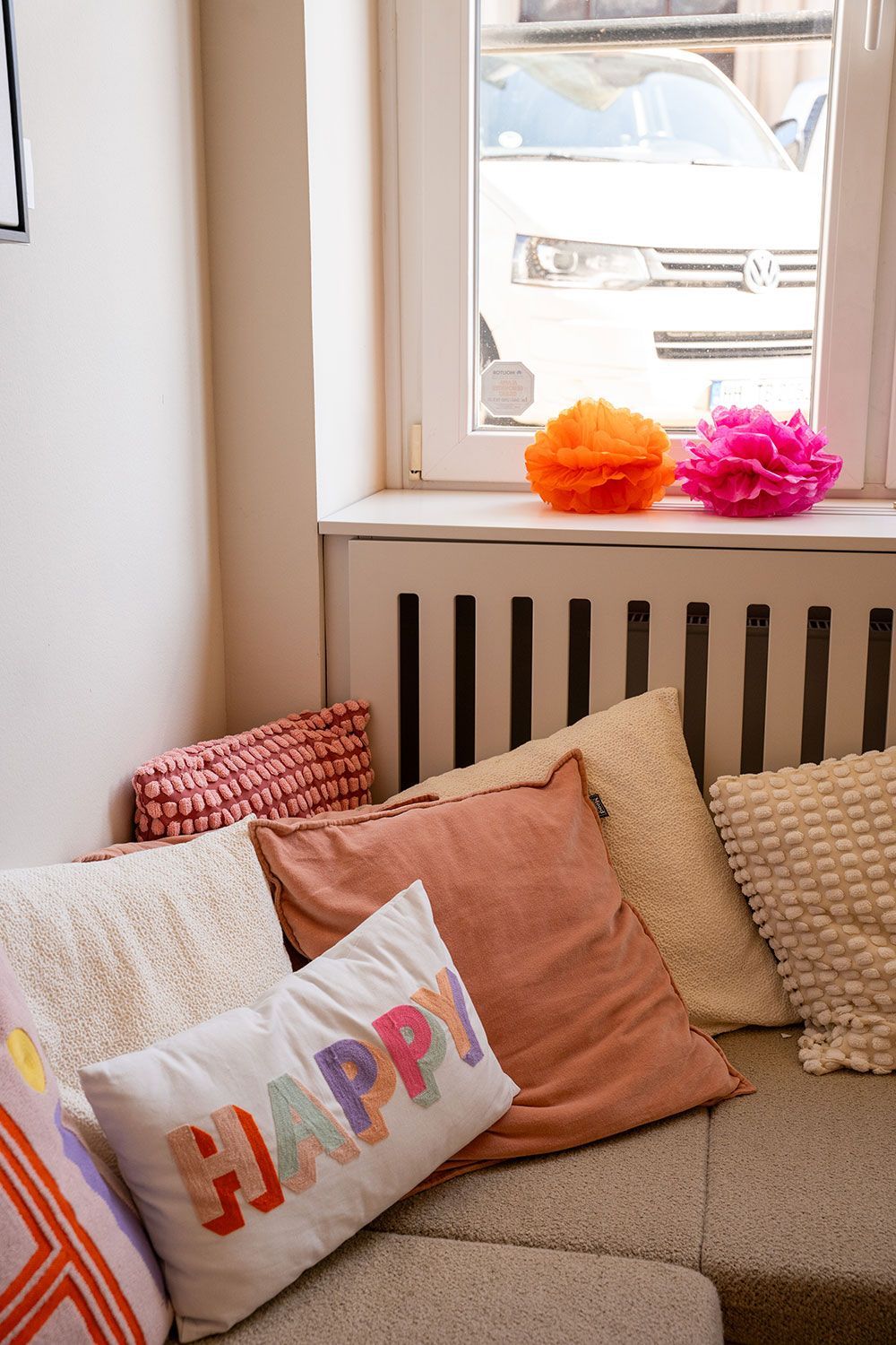 Ein Sofa mit einem Kissen mit der Aufschrift „Happy“ darauf