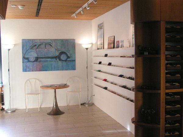 Ein Zimmer mit einem Gemälde eines Autos an der Wand und Billenausstellung