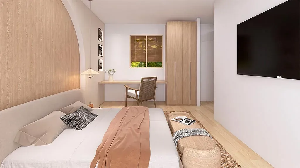 Un dormitorio con una cama, silla, escritorio y televisión.