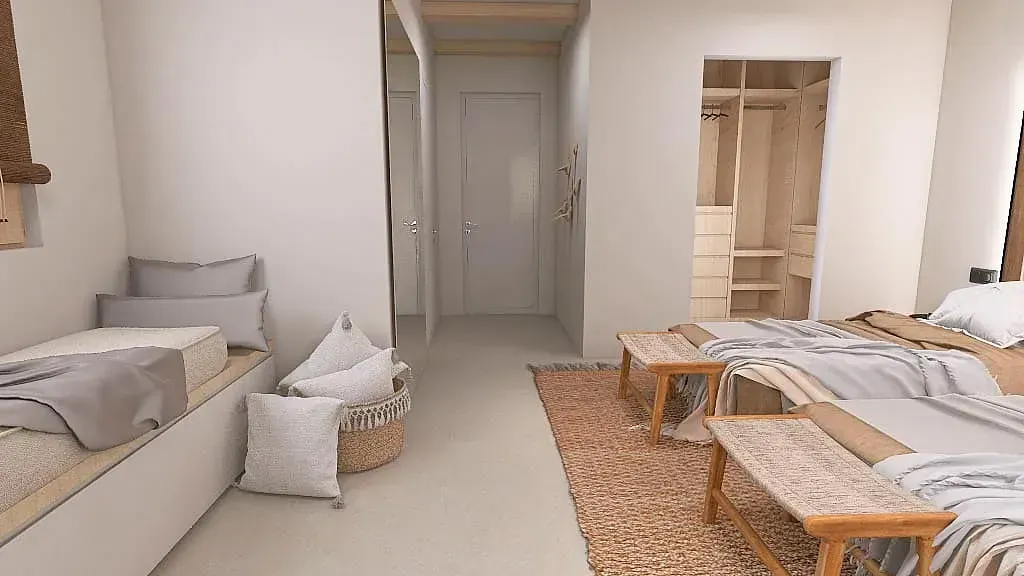 Un dormitorio con dos camas, un sofá y una alfombra.