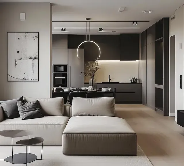 Una sala de estar con sofá, otomana, mesa y cocina.