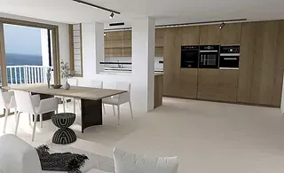 Una sala de estar con mesa y sillas y una cocina con vista al mar.