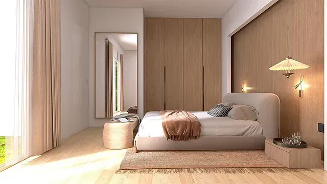 Un dormitorio con cama, espejo, mesita de noche, otomana y armario.