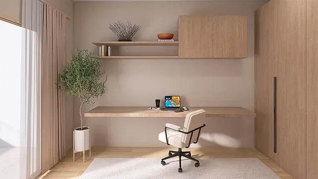 Hay un escritorio con una computadora portátil en la habitación.