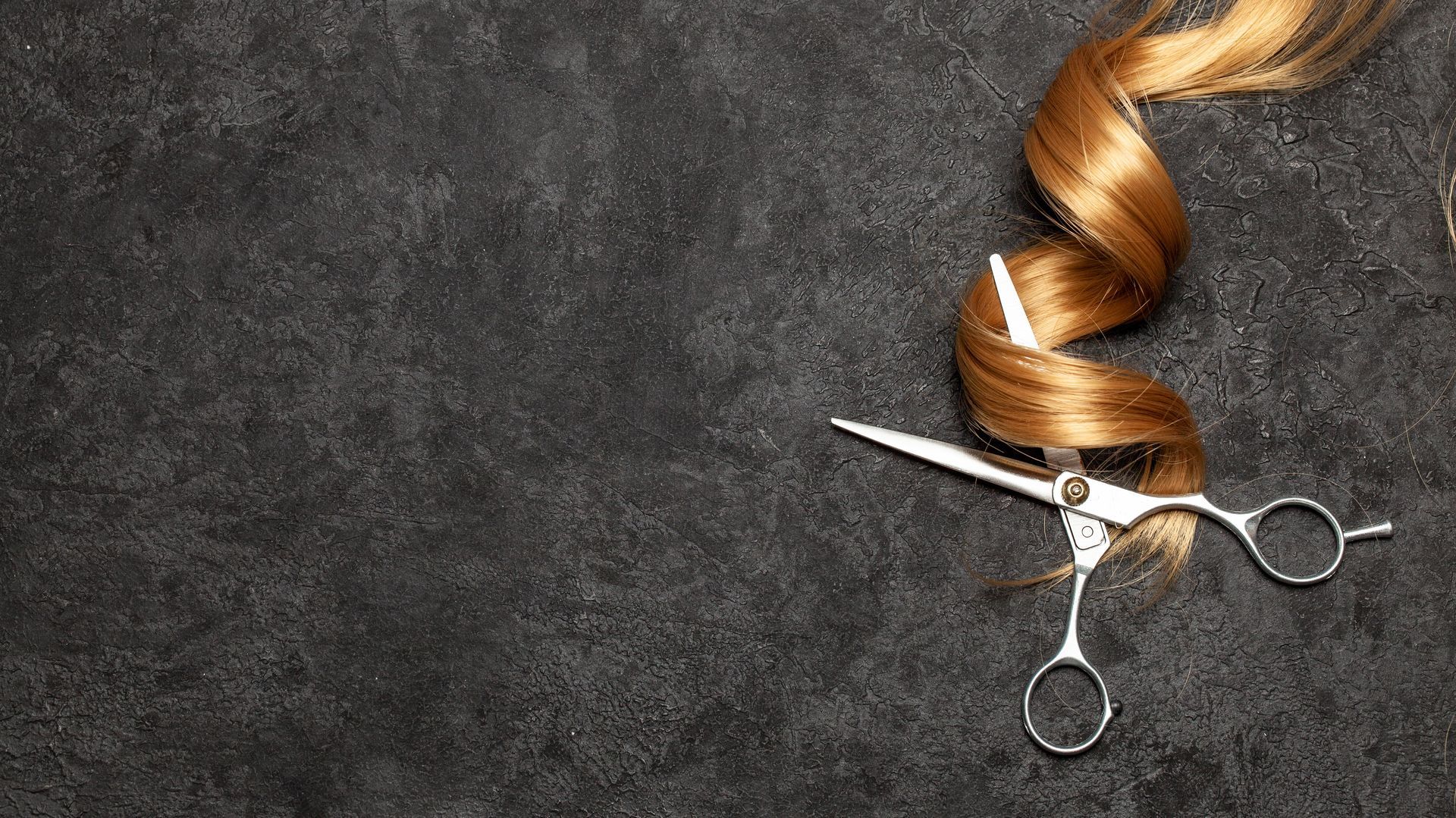 Ein Teller mit Croissants, aus einem davon wurde ein Biss herausgeschnitten, auf einem Holztisch.