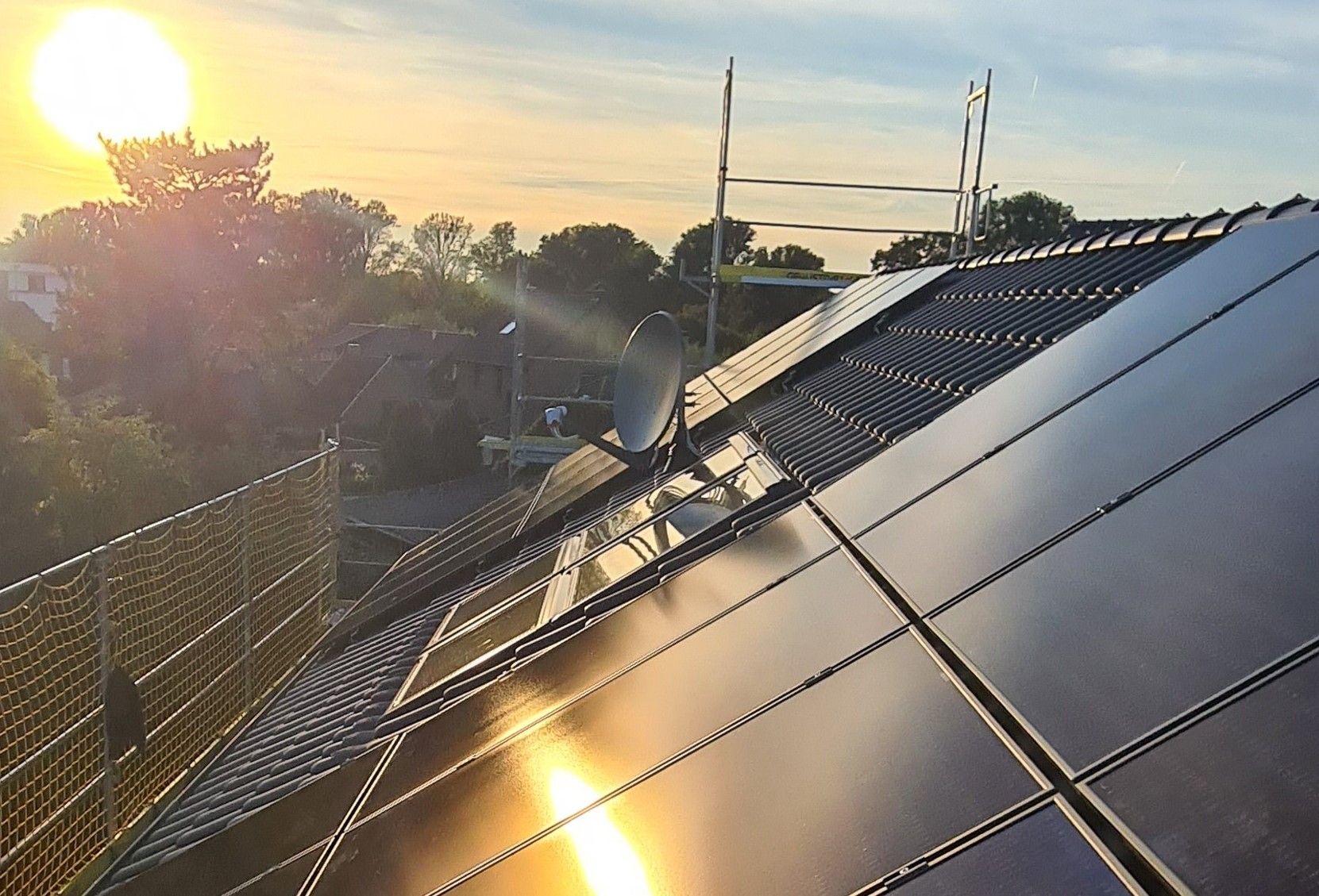 Mitarbeiter von Elektro Hoster installiert eine Photovoltaikanlage auf einem Dach
