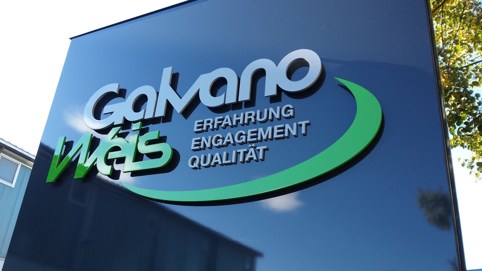 Sign for Galvano Wels, black with white and green text. Reads 