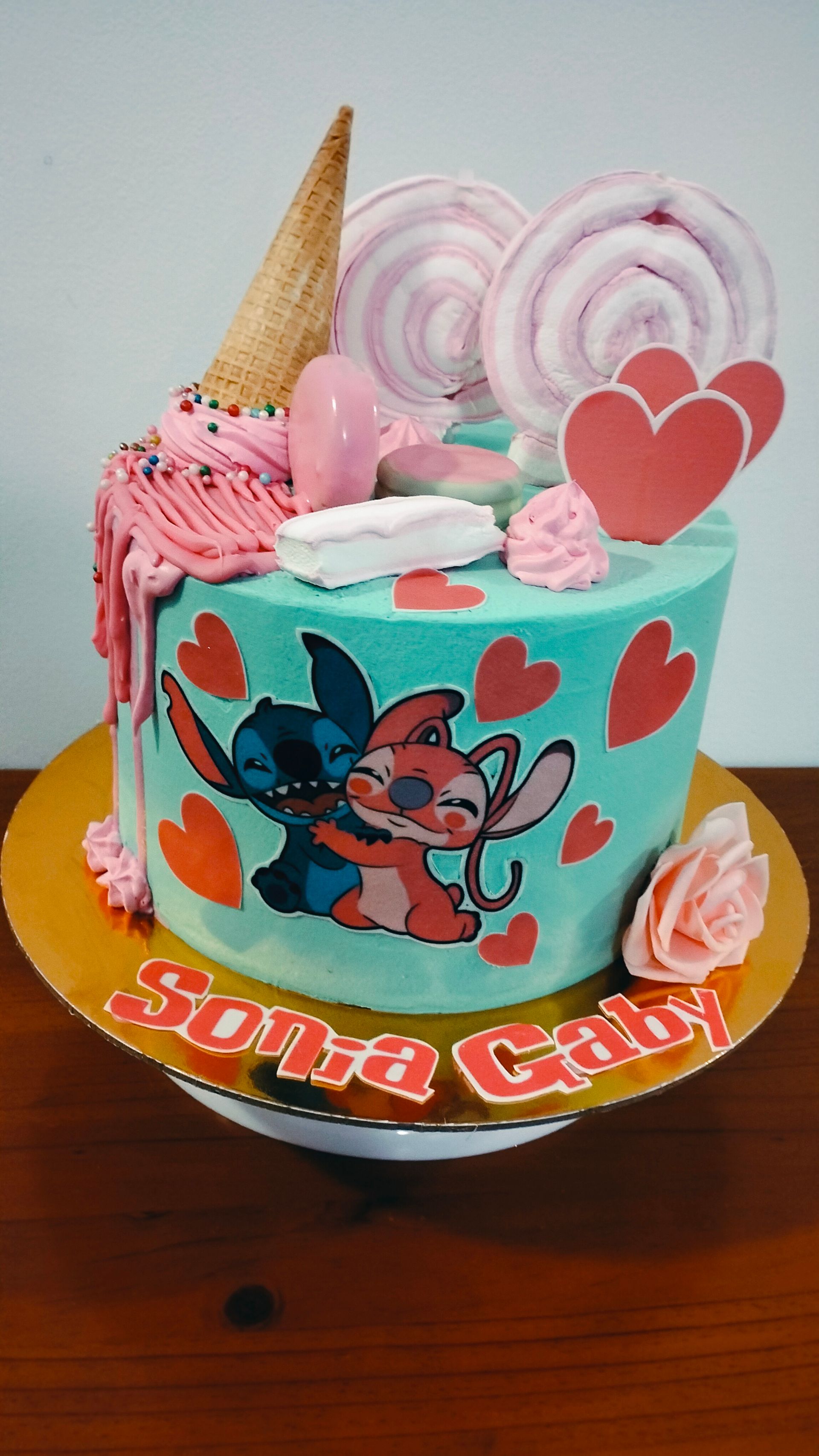 Un pastel con una imagen de Stitch y un ángel.