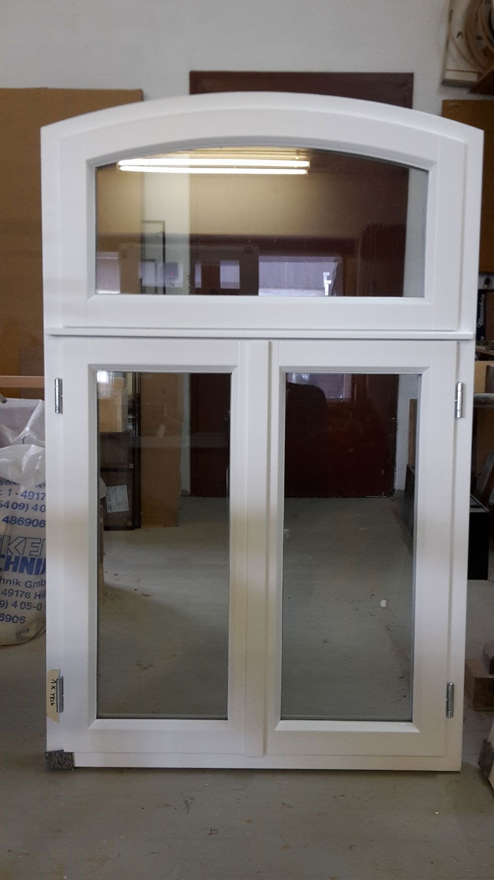 In einem Zimmer befindet sich ein weißes Fenster mit Glasrahmen.