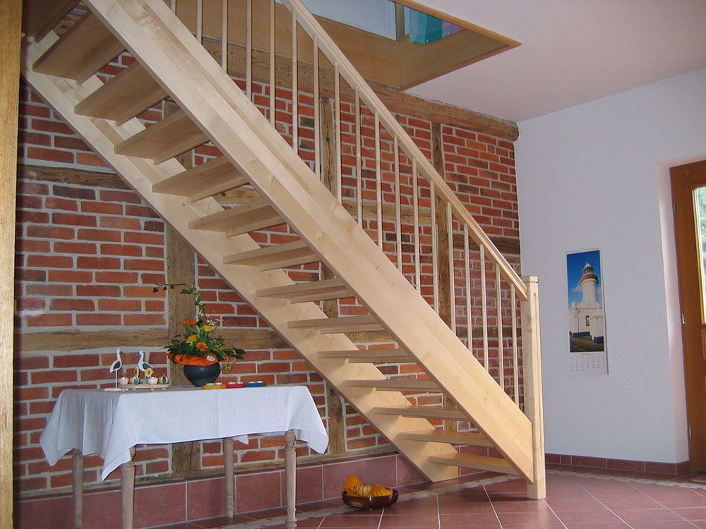 Eine Holztreppe mit einer Ziegelwand dahinter