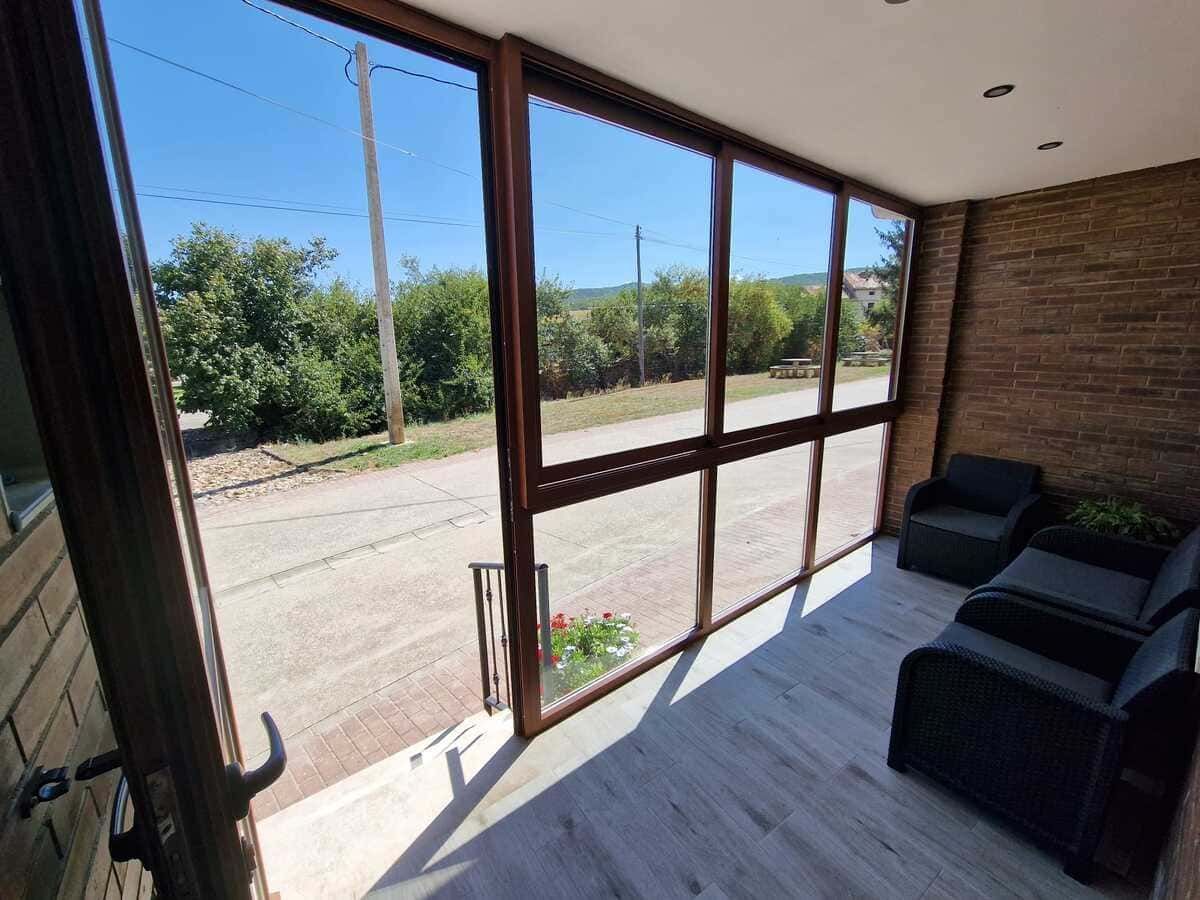 Copas de vino sobre una mesa de madera en una bodega rústica, con barricas junto a las paredes de piedra.