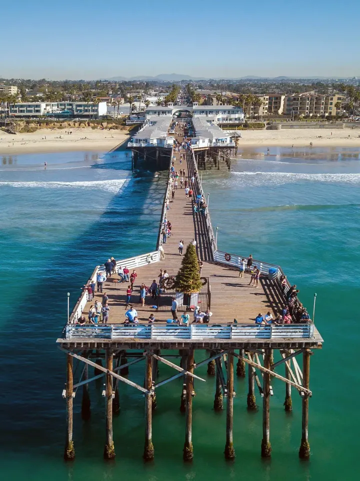 An aerial view of a pier going into the ocean