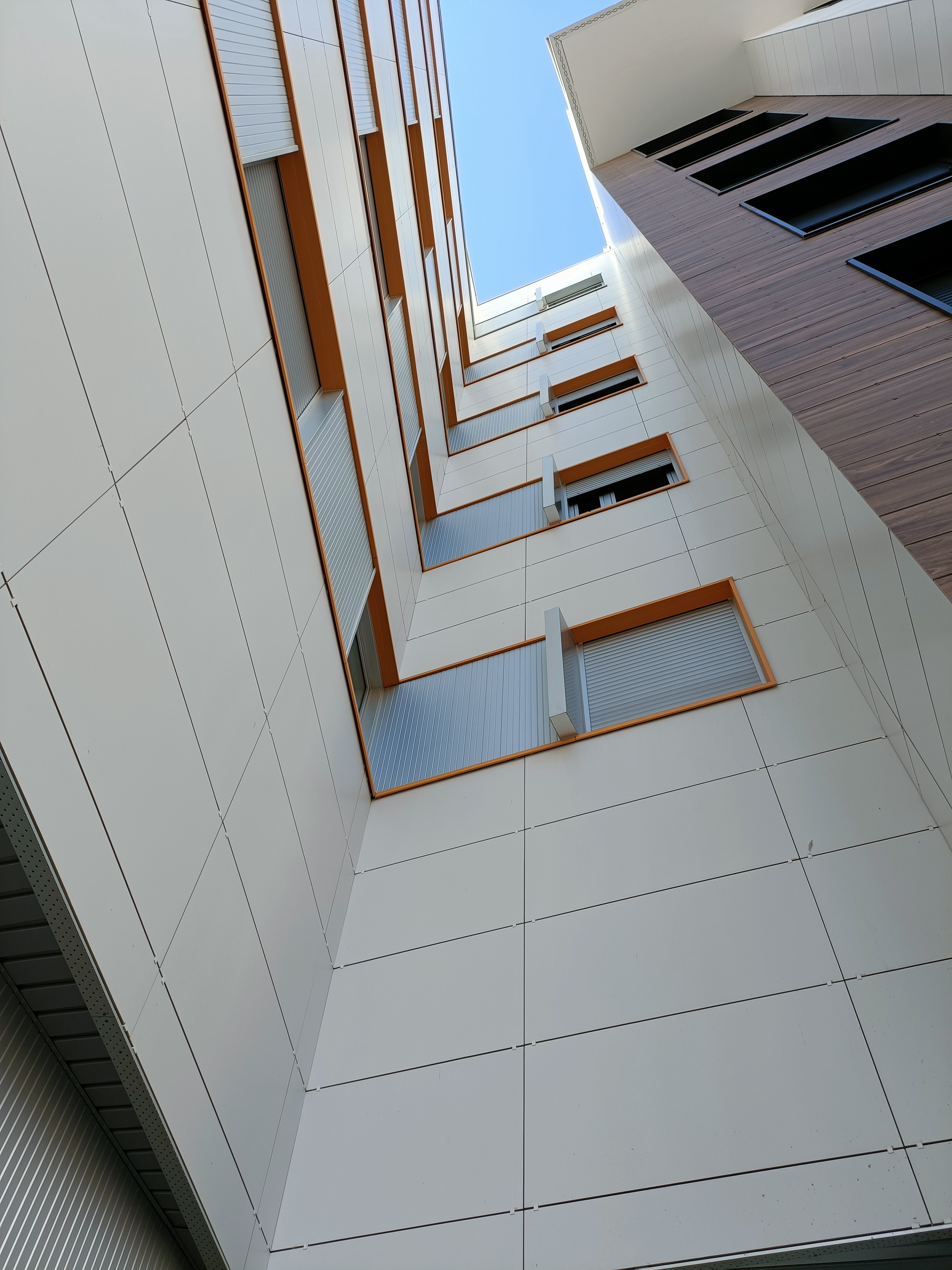 Mirando hacia un edificio alto con un cielo azul de fondo