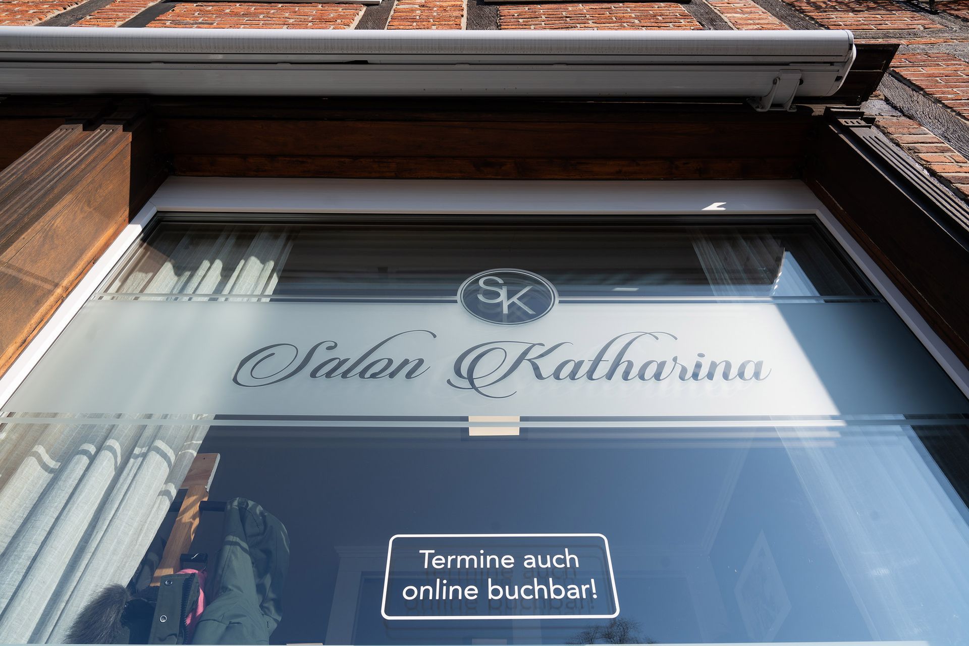 Ein Fenster mit einem Schild mit der Aufschrift „Salon Katharina“