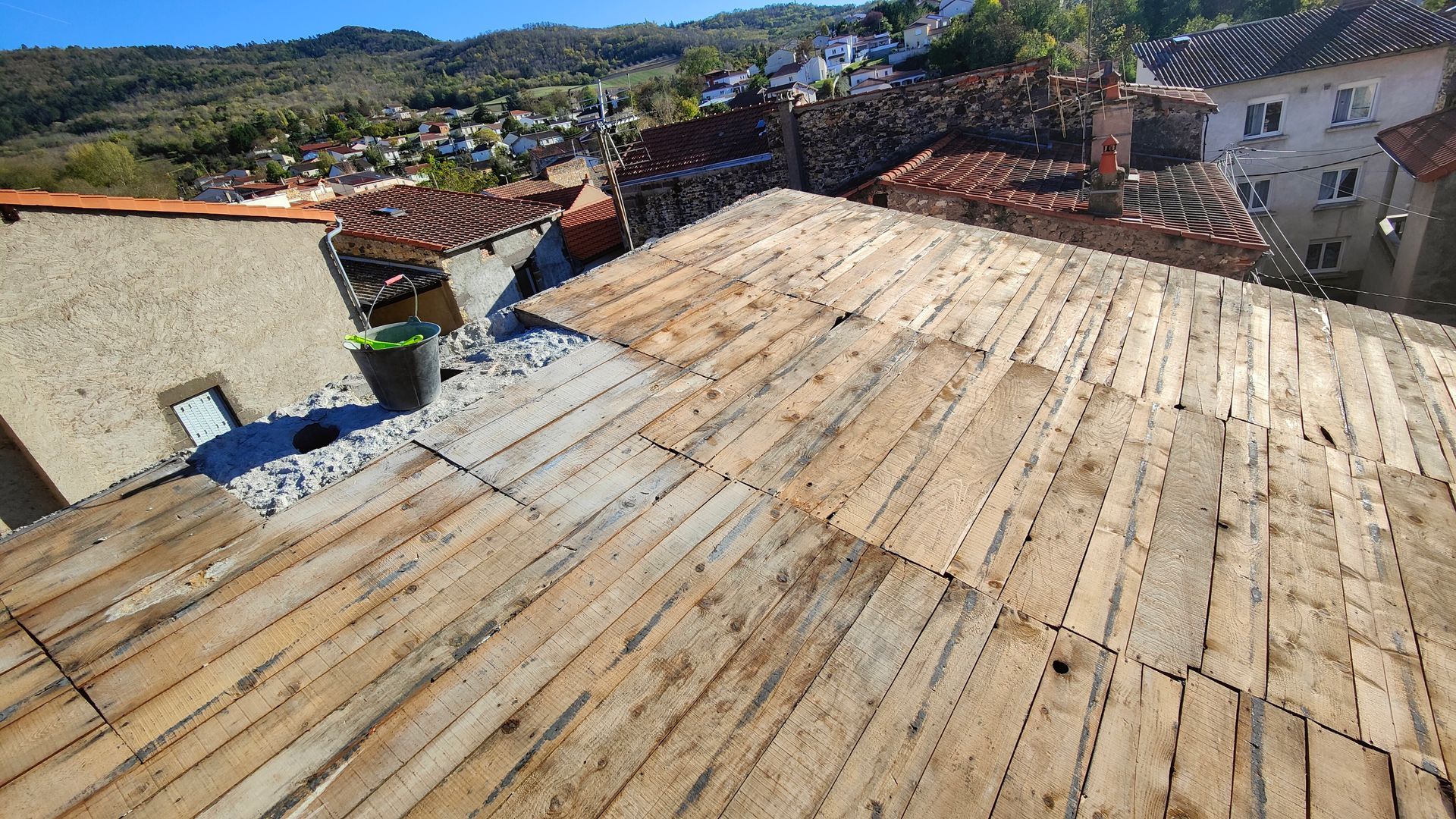 Couche de planches de bois posée sur la toiture