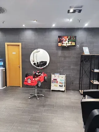 Hay un coche de juguete rojo en el medio de la habitación.