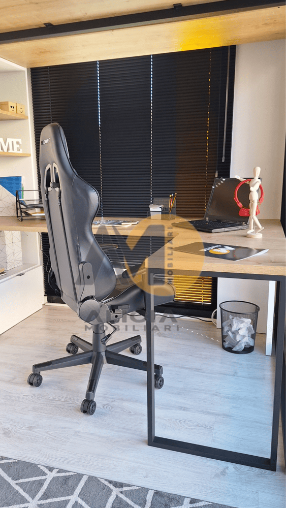 Silla de juego en un escritorio, persianas negras en el fondo y superficie de mesa que parece madera.