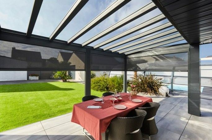 Pergola vitrée avec table à manger dessous